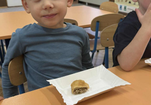 Zdjęcie przedstawia dzieci zajadające różne smakołyki