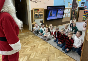 Zdjęcie przedstawia dzieci podczas spotkania z Mikołajem