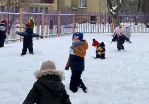 Zdjęcie przedstawia dzieci podczas zabaw na śniegu