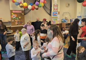 Zdjęcie przedstawia dzieci tańczące z dziadkami