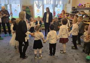 Zdjęcie przedstawia dzieci tańczące z dziadkami