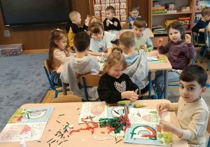 Zdjęcie przedstawia dzieci podczas nauki liter