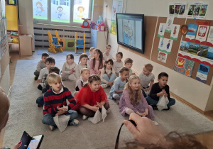 Zdjęcie przedstawia dzieci podczas zabaw z dziadkami