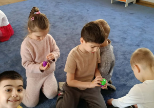 Dzieci rozpakowują znalezione podczas zabaw jajka