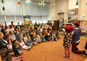 Zdjęcie przedstawia dzieci w trakcię występu magika